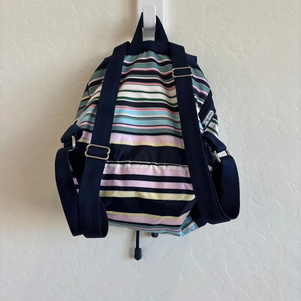 LeSportsac Voyager drawstring backpack in a navy pastel stripe pattern.